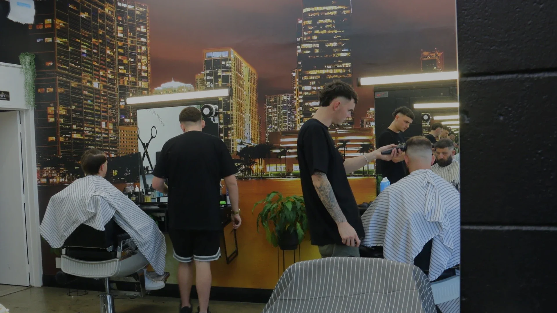 Barber Spence barbers working with clients inside the Brookfield shop