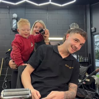 A Barber Spence barber with a young client and family