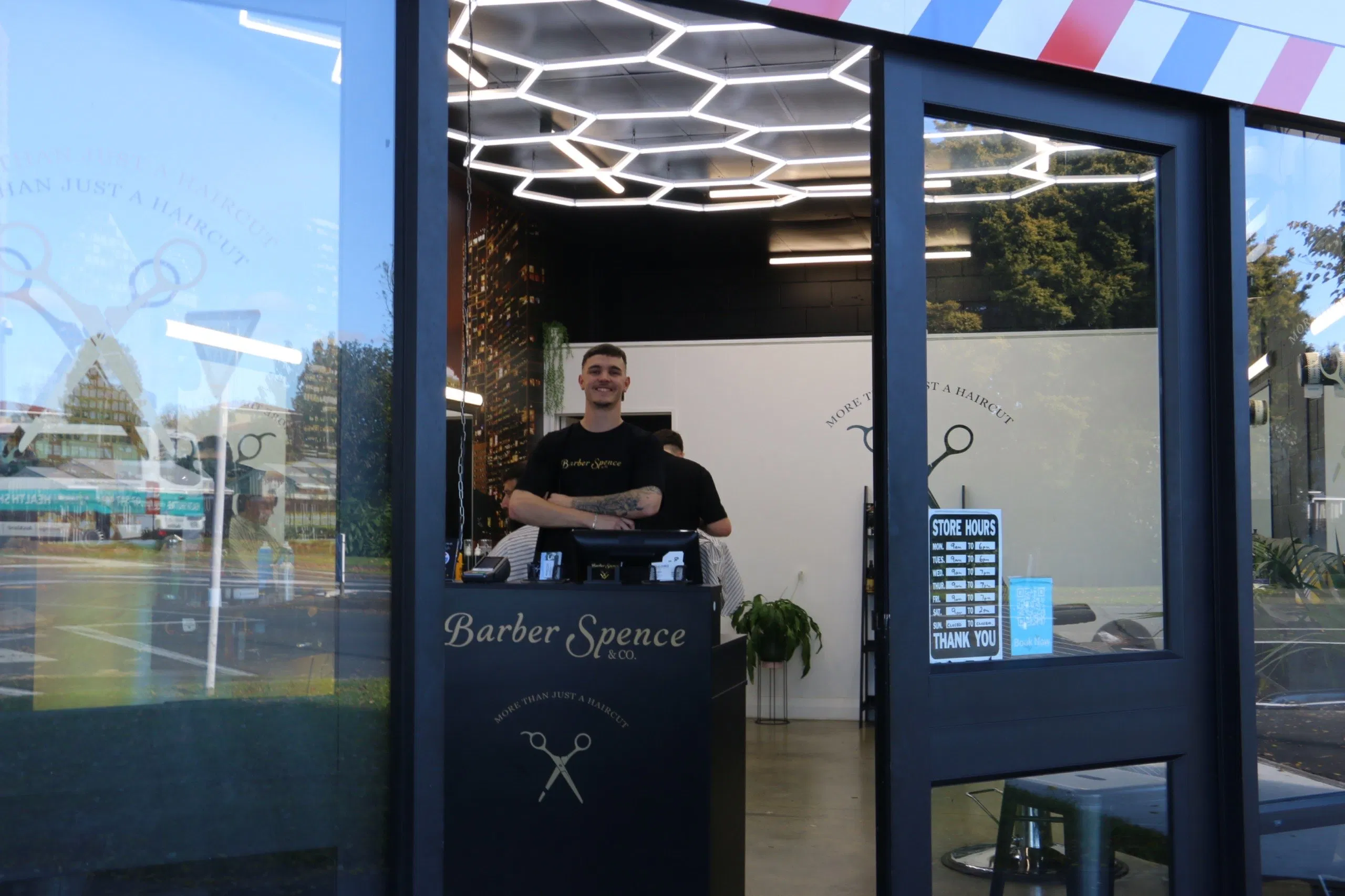 Spencer at the counter inside Barber Spence and Co.