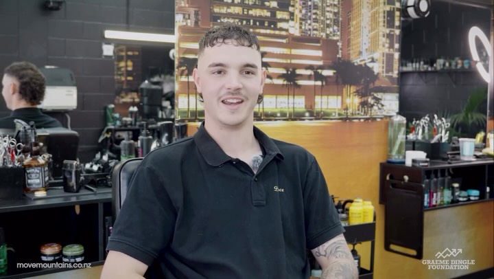 Spencer speaking inside the Barber Spence shop