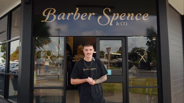 Spencer welcoming viewers outside the Brookfield storefront